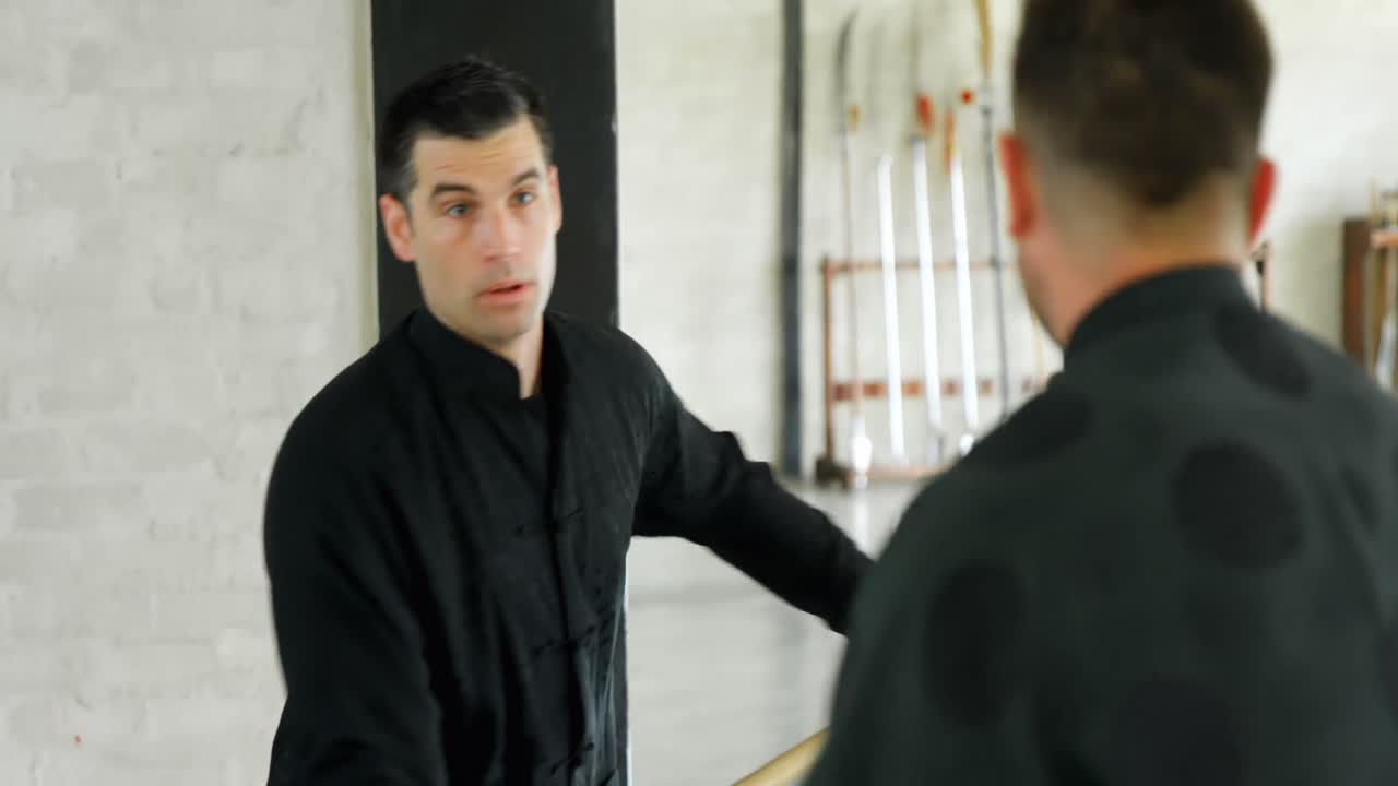 Kung fu fighters practicing martial arts with whip stick 4k