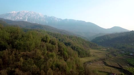 golden time of the sunset in the forest with a scenic view of wide landscape of snow mountain in alps swiss terrace rice paddy agriculture in the land of persian iran style nature travel middle east