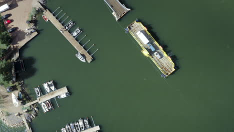 Aerial-top-down,-drone-shot-view-above-a-cable-ferry-and-a-harbor,-in-the-archipelago-of-Porvoo,-sunny,-spring-day,-in-Uusimaa,-Finland---Screwdriver,-drone-shot