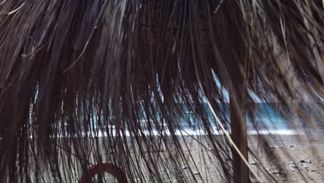 parasol on spanish beach with wind moving the umbrella