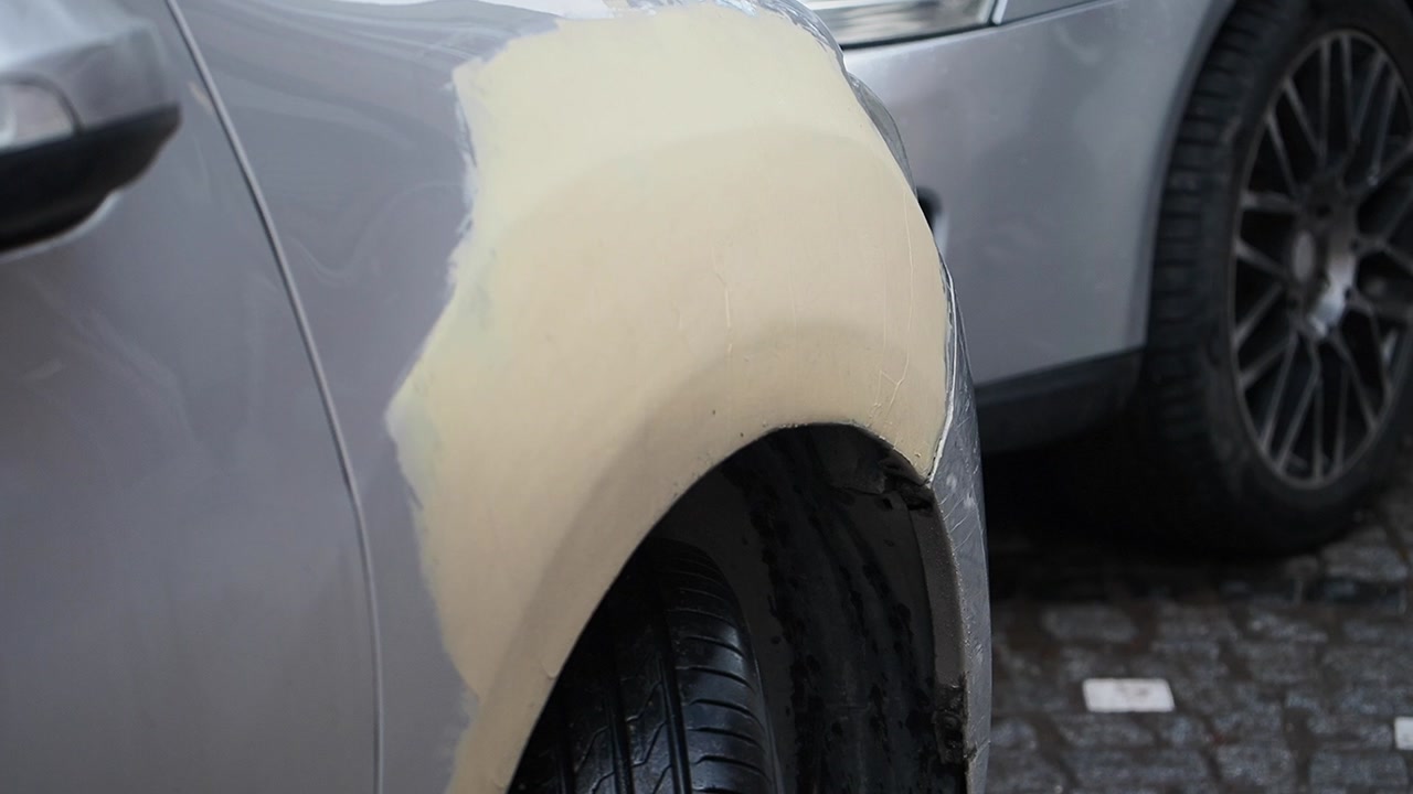 Close-up of Car Fender with Body Filler During Repair