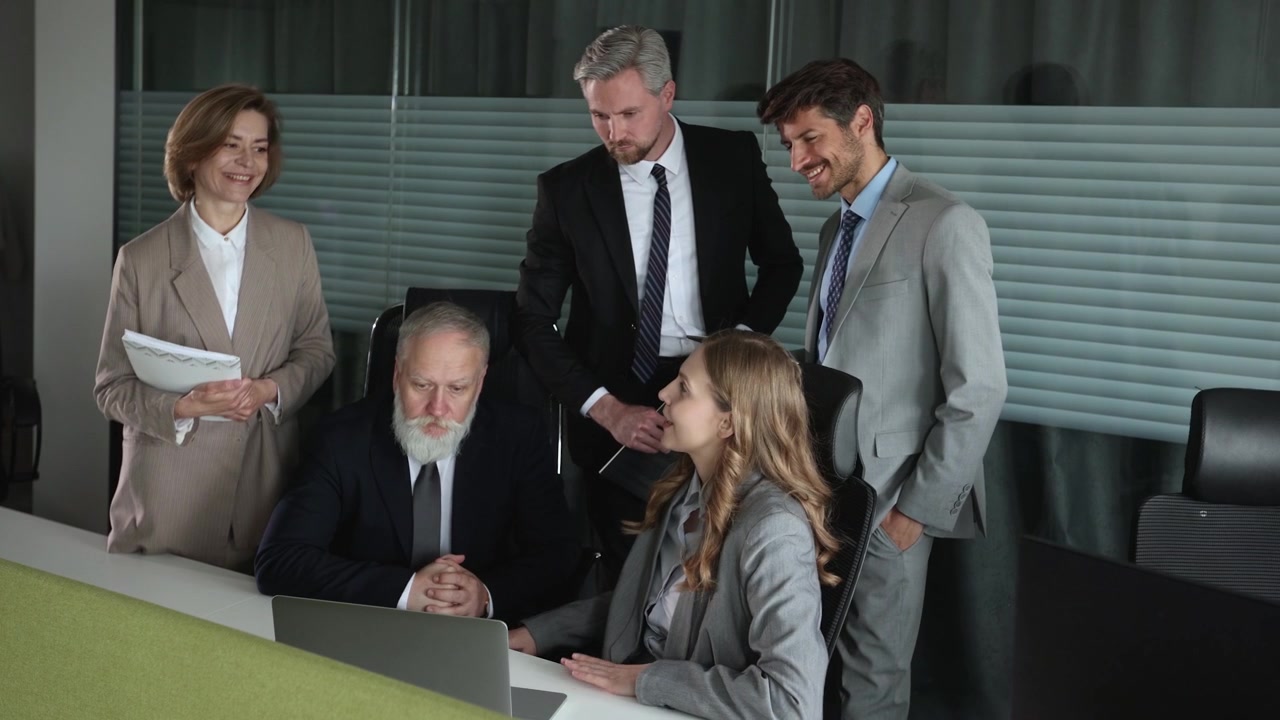 Business Team Discussing Project on Laptop in Modern Office