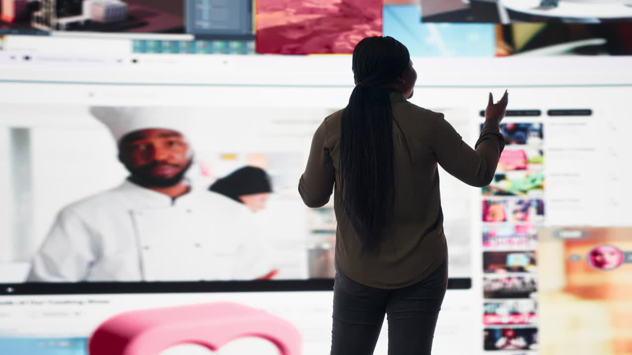 Woman entertained by video content on digital wall of screens