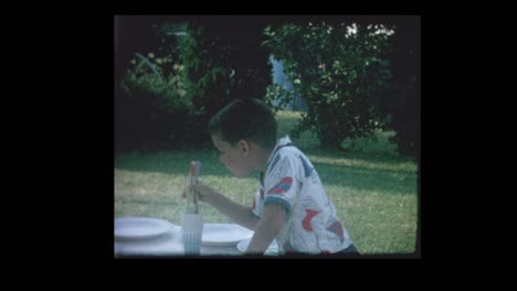 1964 young boy sets picnic table