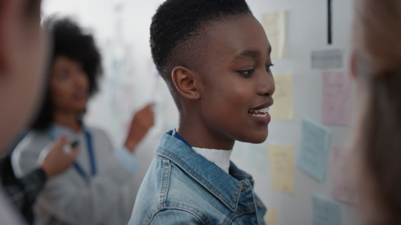 african american business woman using sticky notes brainstorming with colleagues in meeting team leader sharing creative problem solving ideas for solution enjoying teamwork in startup office