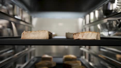 slices of fish cooking under a grill with a close-up view of the searing process