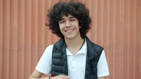 smiling teenager giving thumbs up