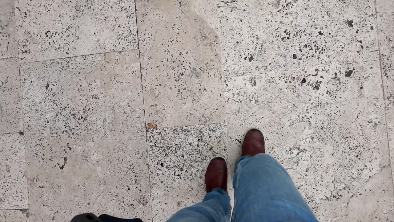 Person walking on a tiled floor