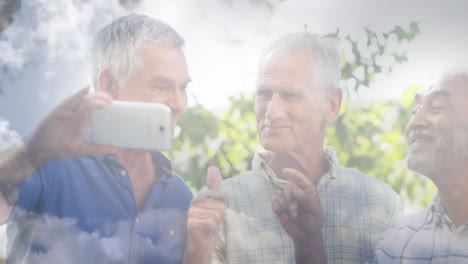 animation of glowing light over smiling senior men using smartphone