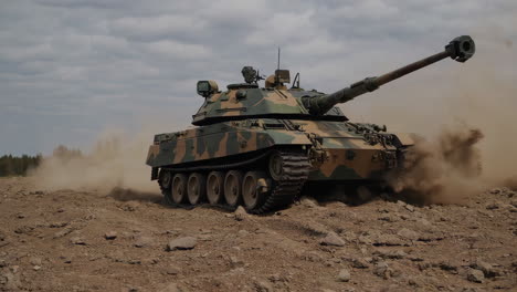 military tank driving through desert terrain
