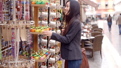 Smiling-young-woman-checking-out-shop-merchandise