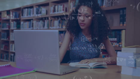 animation of mathematical equations over happy biracial female student using laptop in library