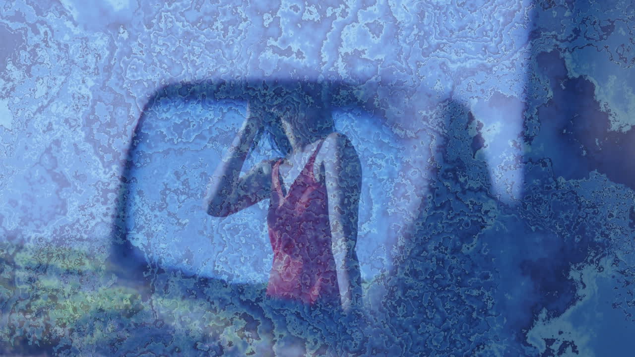 Creating abstract effect, person in red dress seen through frosted glass