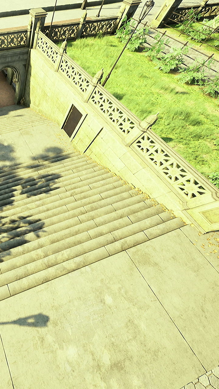 Stairs leading down to a green park area on a sunny day in the city