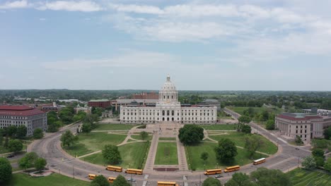 aerial wide reverse pullback shot of the grounds surrounding the minnesota state capitol building in saint paul, minnesota