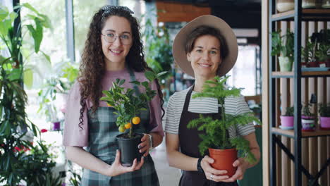 two happy women plant shop employees
