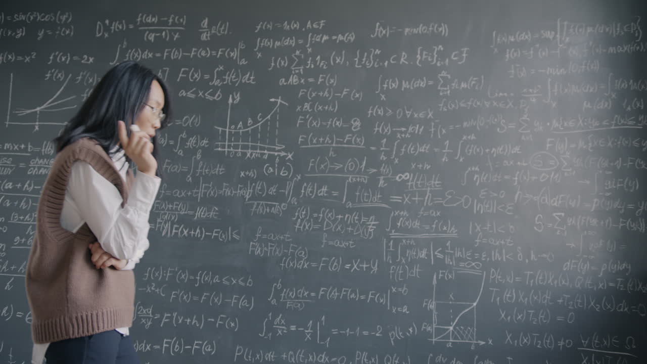 Woman Studying Mathematics on a Chalkboard