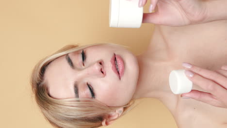 woman holding skincare cream containers