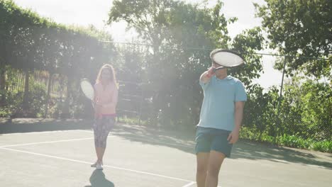 video of happy biracial couple playing tennis on the court