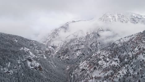 snowy utah mountains in american fork canyon valley - aerial forward approach