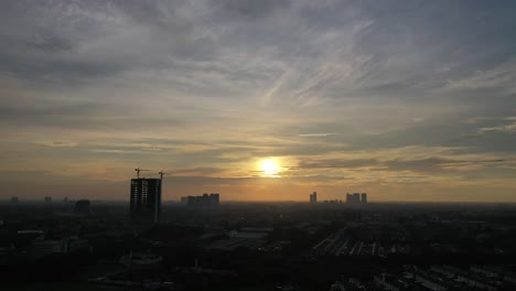 sunrise over a bustling city skyline with construction