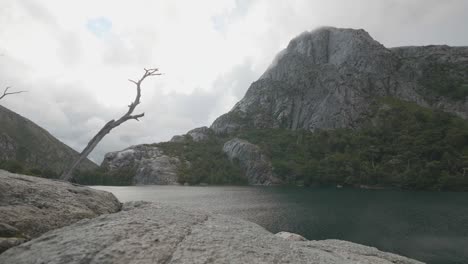 huge granite mountain with a pristine lake and dead nature