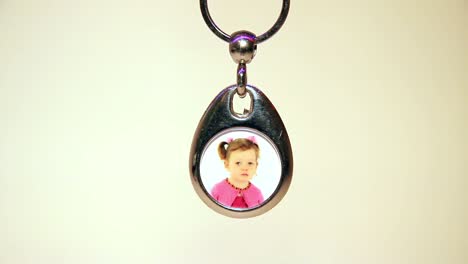 Close-Up-of-the-Hanging-Child's-Photo-in-Metal-Souvenir-Keychain