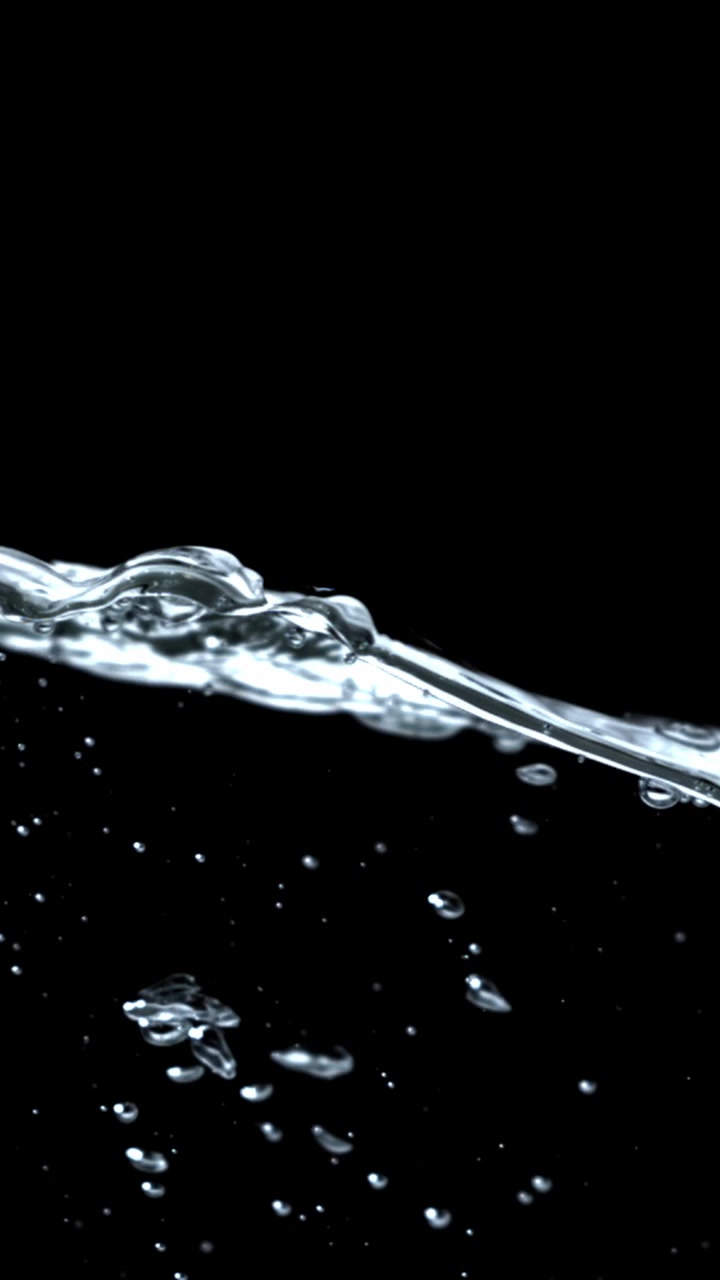 Clear Water Splashing and Bubbling Against a Black Background