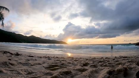 sunset timelapse on anse lazio tropical beach in praslin island seychelles with clouds and sand and palm trees