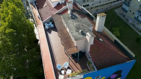 Aerial-drone-view-of-roofs-of-buildings-in-bright-colours,-during-daylight-in-the-city-of-Lisbon,-Portugal