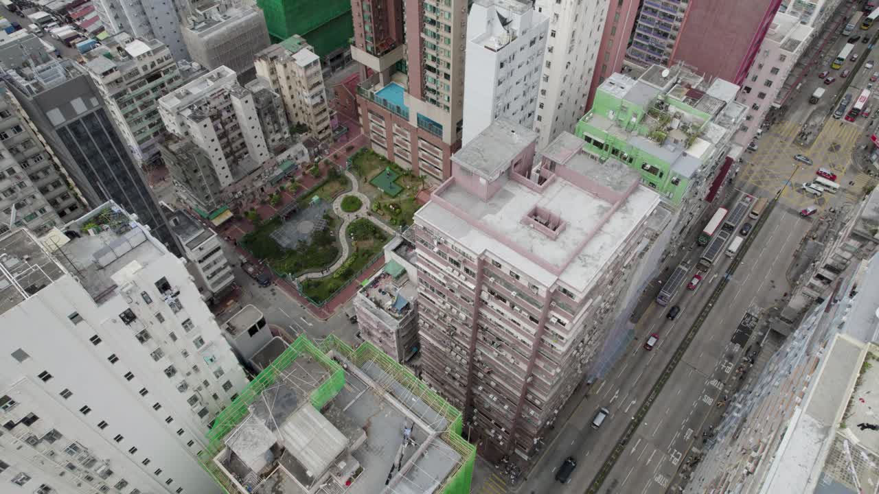 Hong Kong top-down circular Aerial view over the Kowloon district, and busy Mong Kok streets with a view of a nice park in the urban area surrounded by buildings and dense urban planning
