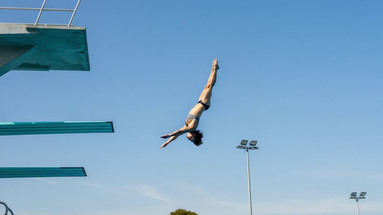 A Flawless Dive Sequence: Capturing the Grace and Skill of a Diver Transitioning from Air to Water in a Sunny Outdoor Pool Environment
