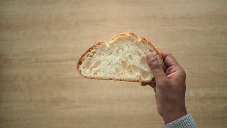 person holding a slice of bread