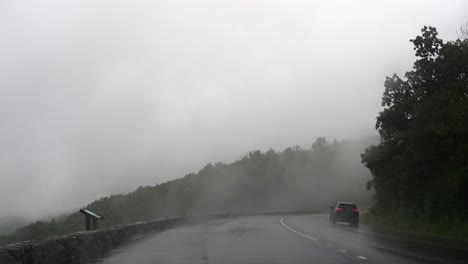 car driving on a foggy mountain road