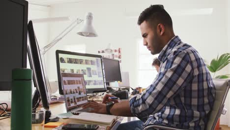 Side-view-of-two-colleagues-working-in-creative-office