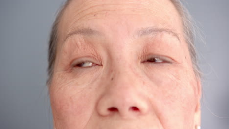 close-up of elderly woman's face with focus on eyes and wrinkles