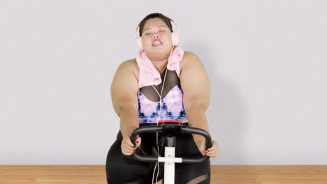 obese woman exercising on exercise bike