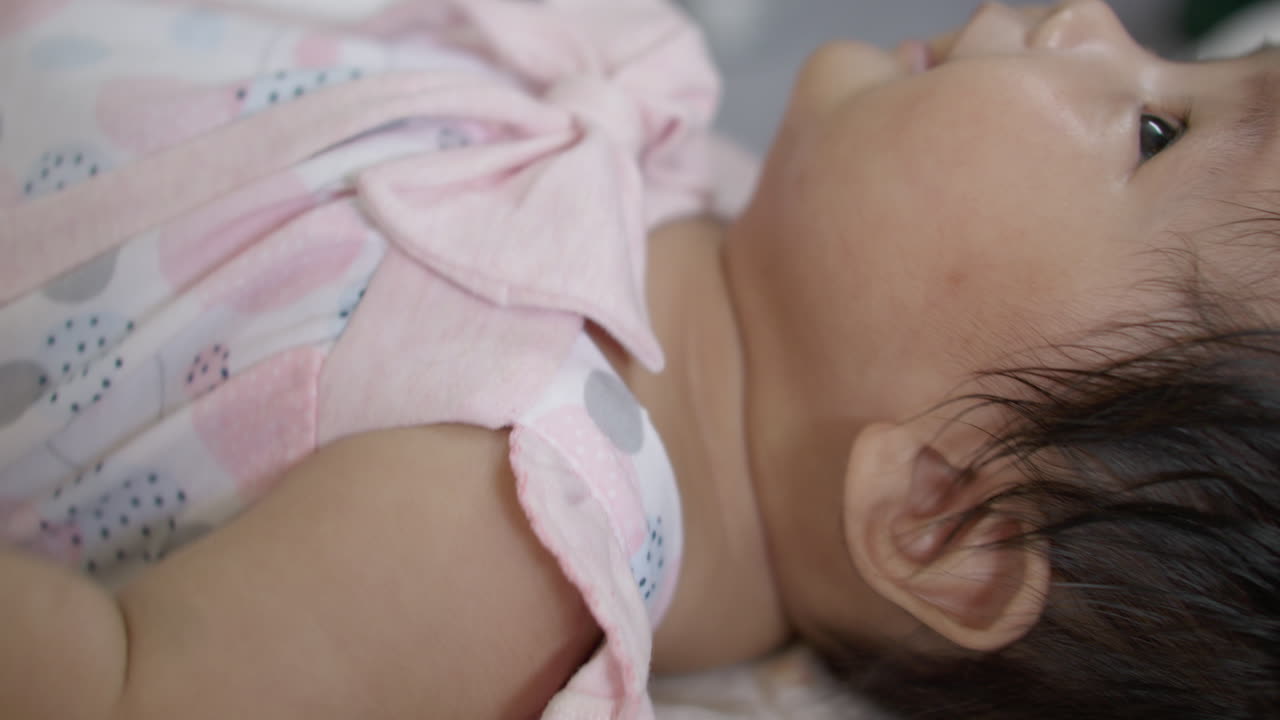 Adorable Baby Girl Sleeping in Pink Dress