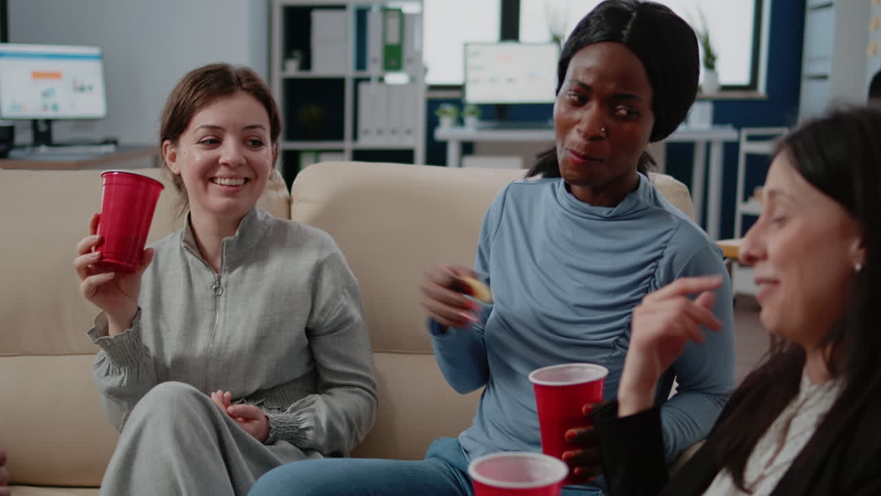 Multi ethnic group of people enjoying beer and pizza to have fun