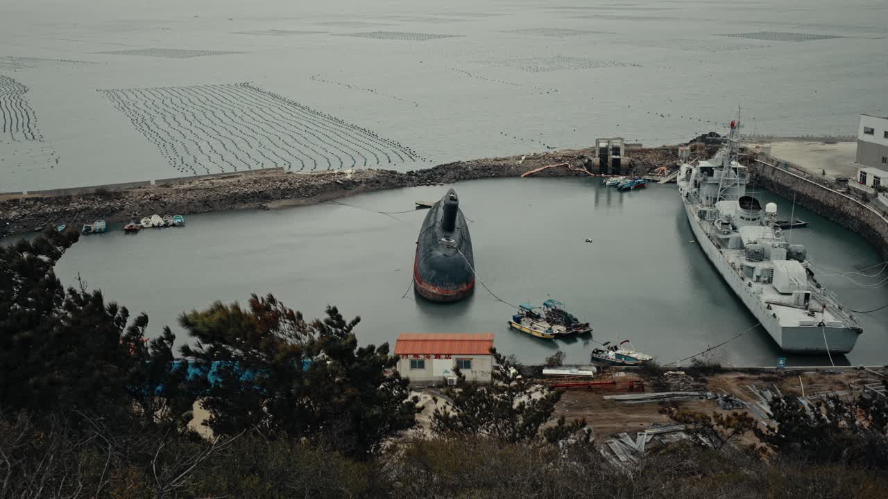 Overhead View of a Submarine and Warship Docked in a Coastal Harbor