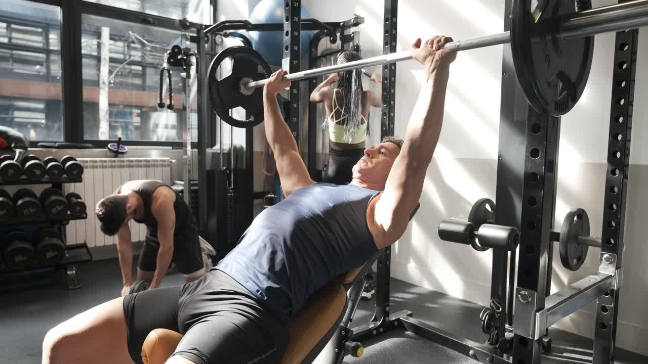 Man Bench Pressing in Gym