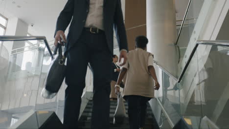 businesspeople walking upstairs in a modern hotel lobby