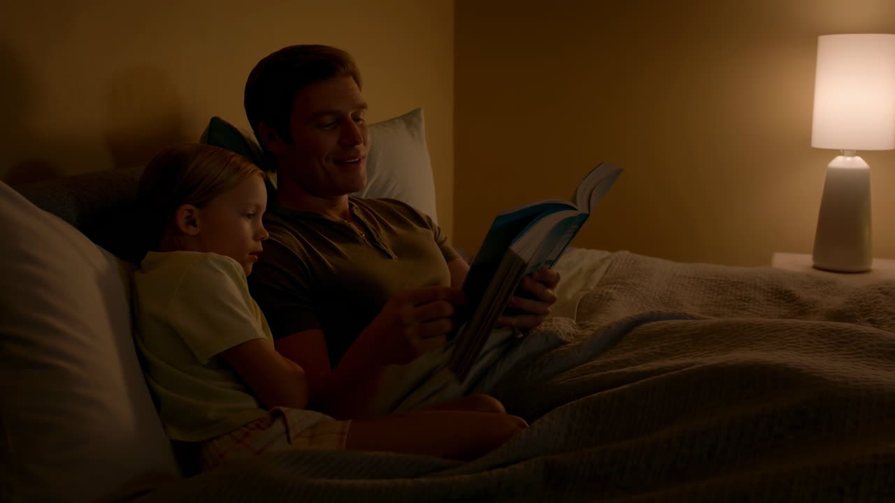 Caucasian Father Reading Bedtime Story, Soft Lamp Light, Cozy Bedroom, Father And Young Daughter Cuddled