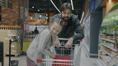 father and daughter shopping at the supermarket