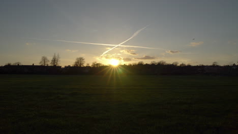 King-George's-park-in-London-at-Sunset,-wind-blowing-through-the-trees-at-golden-hour