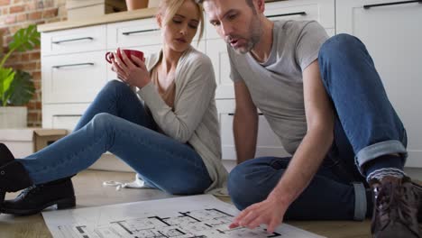 Tilt-up-video-of-couple-discusses-the-apartment-plan