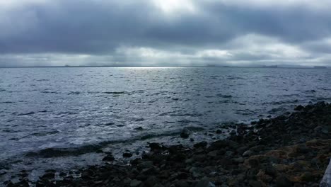 the shore under cloudy, overcast skies in the bay