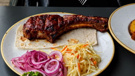 eating tomahawk steak with pita and vegetable salad on the side. - closeup shot