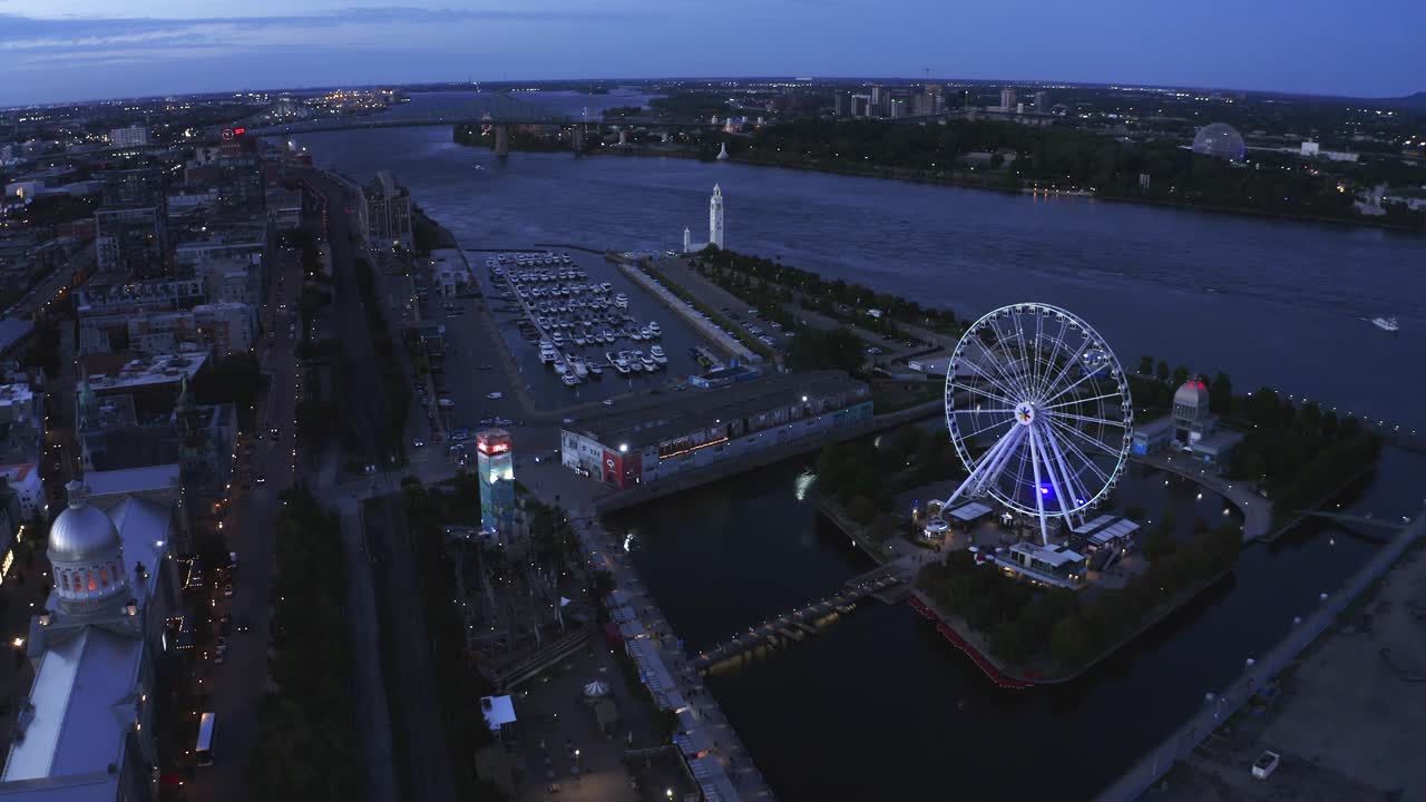 Aerial shot of Montreal's Old Port with the Ferris wheel in view, showcasing the vibrant waterfront and historic architecture. Perfect for capturing the essence of the city.