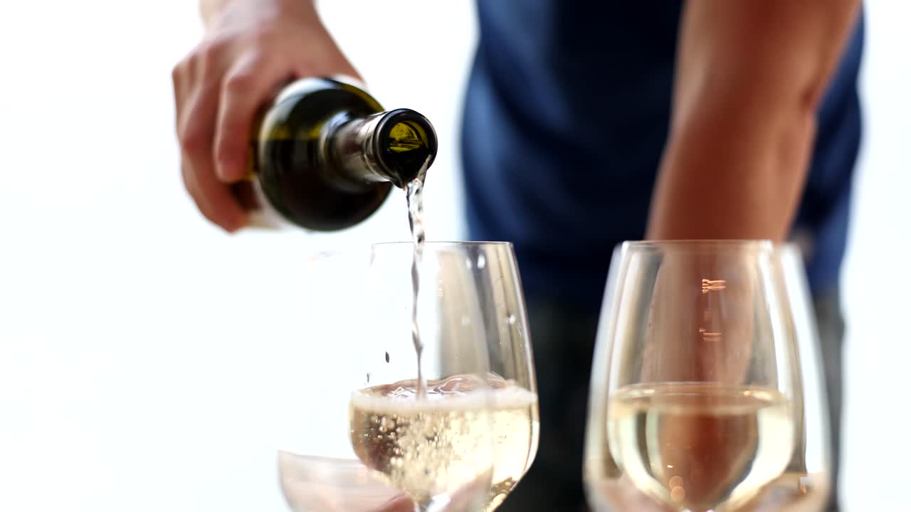 Pouring wine into glasses